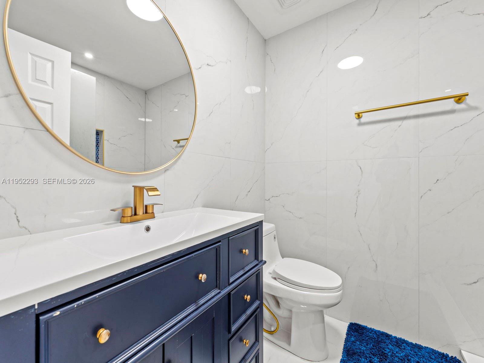 15626 Southwest 100th Terrace Miami, FL 33196 - Photo 26 of 30 a bathroom with a sink a toilet and a mirror