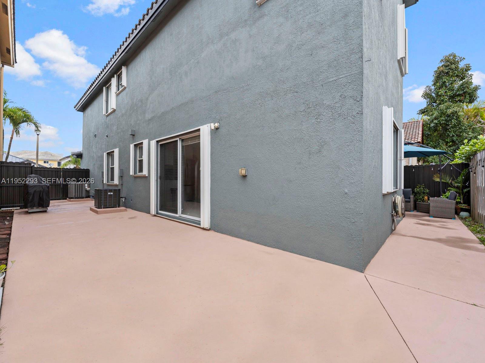 15626 Southwest 100th Terrace Miami, FL 33196 - Photo 30 of 30 a bedroom with a bed and a view of balcony