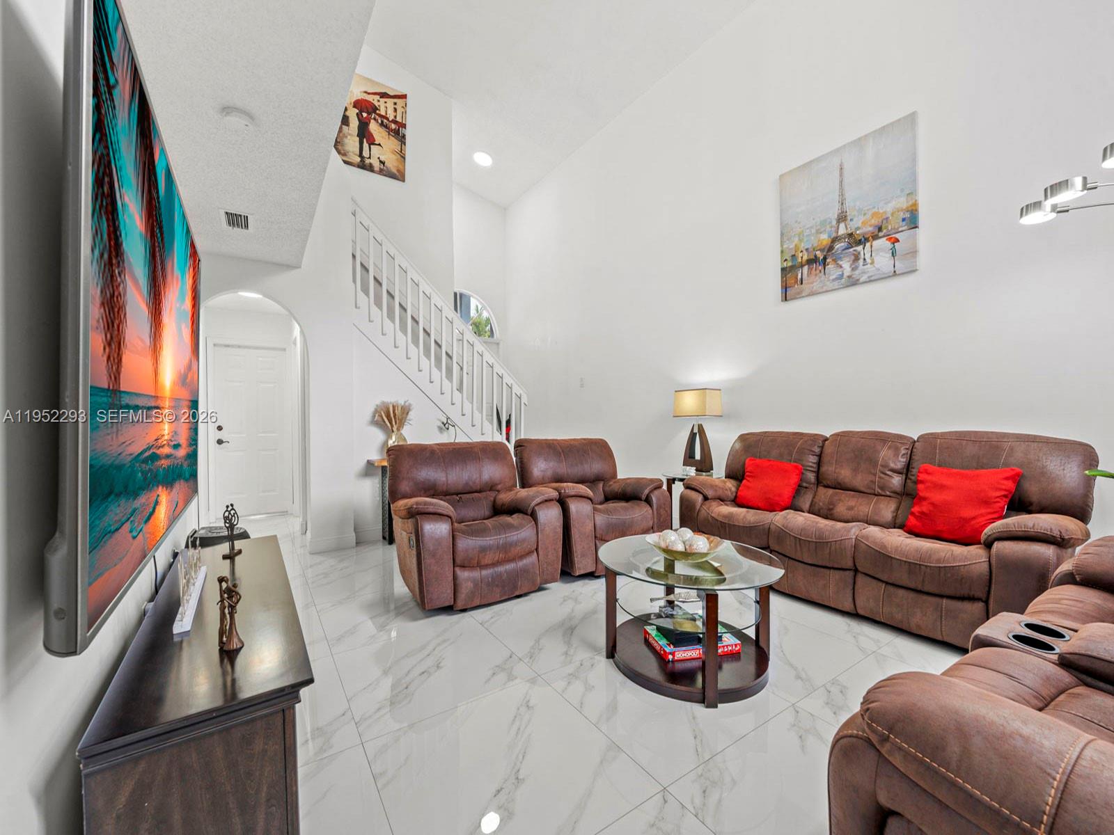 15626 Southwest 100th Terrace Miami, FL 33196 - Photo 4 of 30 a living room with furniture and a flat screen tv