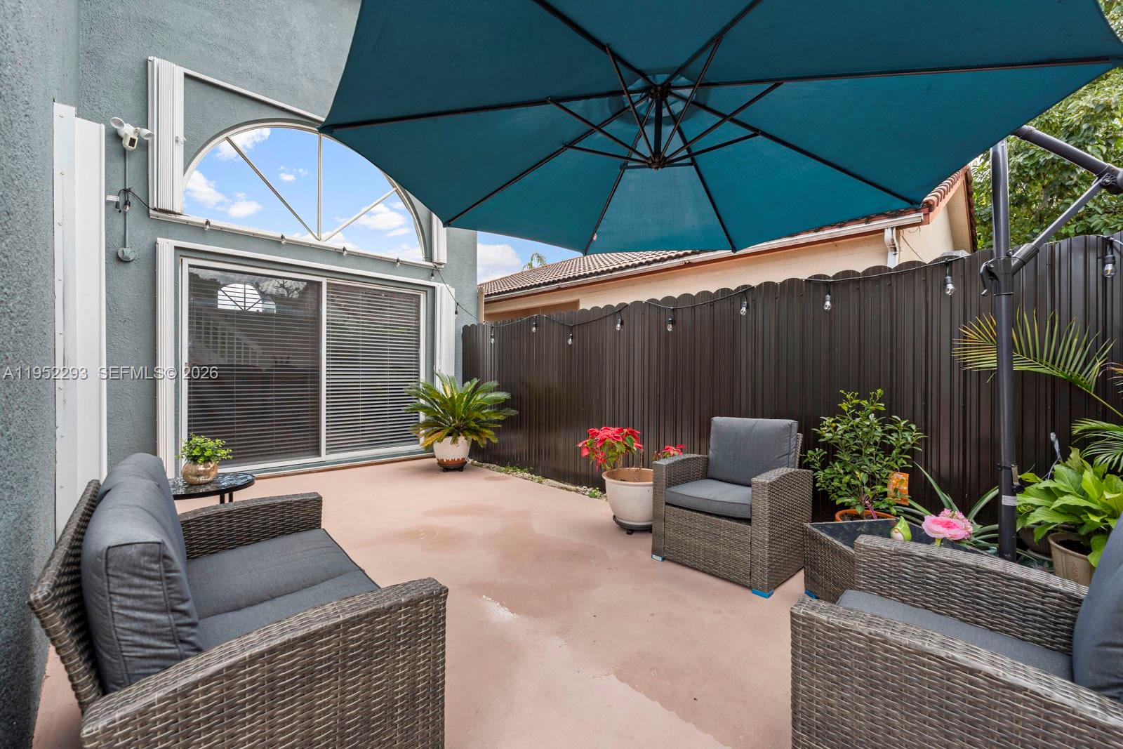 15626 Southwest 100th Terrace Miami, FL 33196 - Photo 5 of 30 a view of a chair and tables in the patio