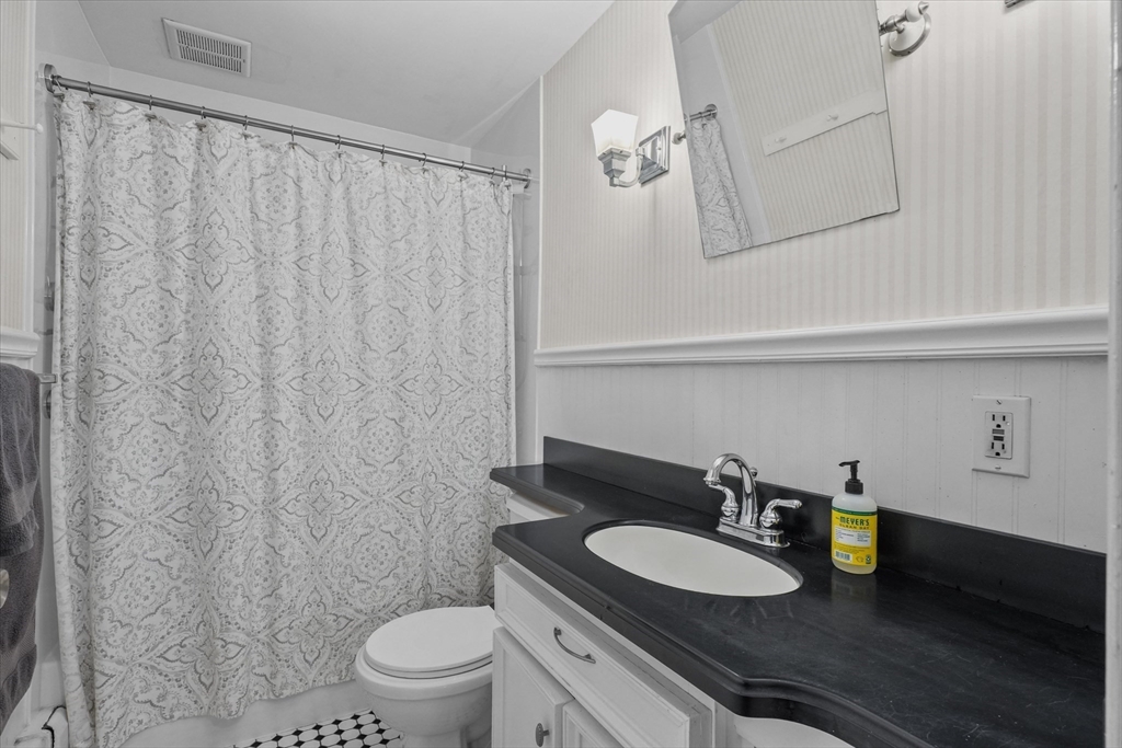 201 Humphrey Street, Unit 2 Marblehead, MA 01945 - Photo 25 of 31 a bathroom with a sink a toilet and a mirror