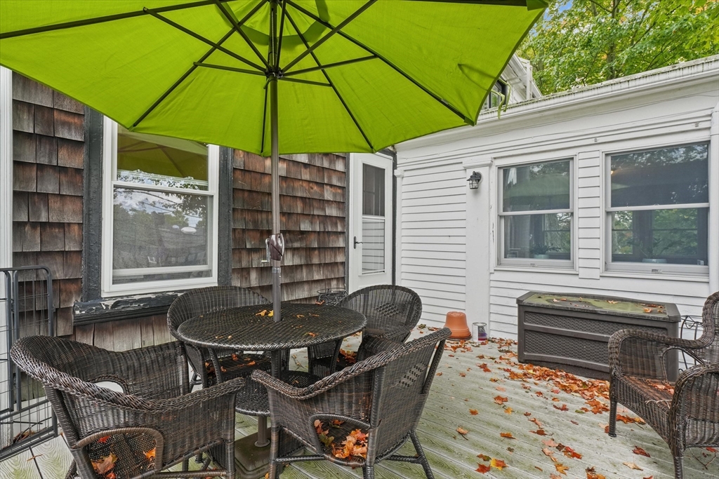 201 Humphrey Street, Unit 2 Marblehead, MA 01945 - Photo 27 of 31 a patio with a table and chairs under an umbrella