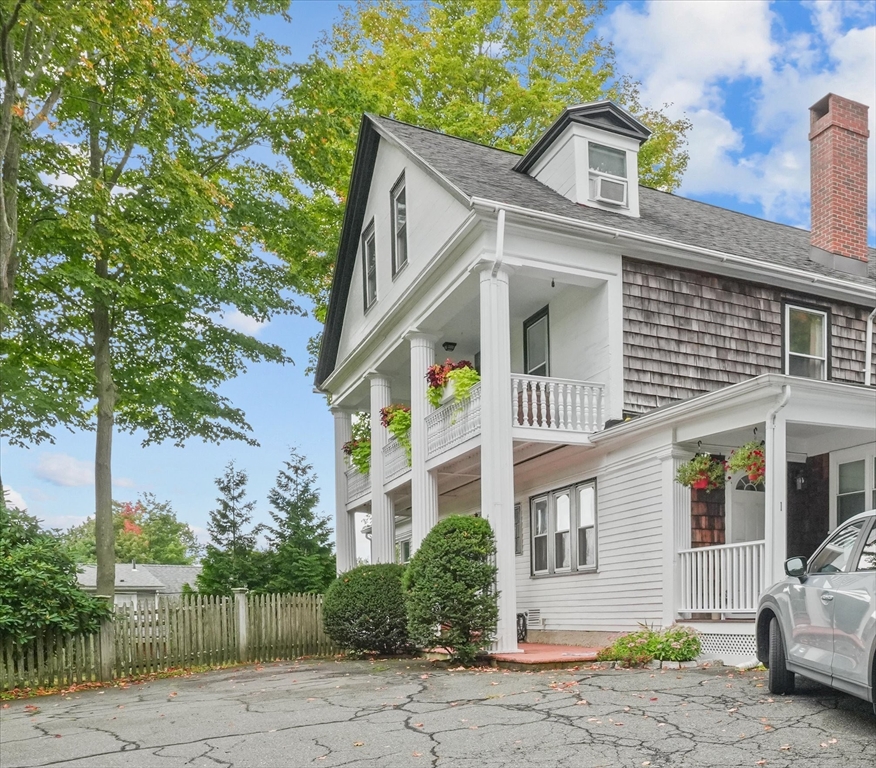201 Humphrey Street, Unit 2 Marblehead, MA 01945 - Photo 4 of 31 a view of a white house with large windows and a small yard