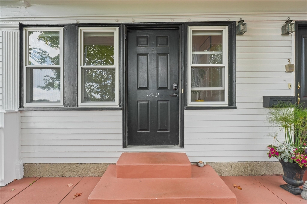201 Humphrey Street, Unit 2 Marblehead, MA 01945 - Photo 5 of 31 a front view of a house with a yard