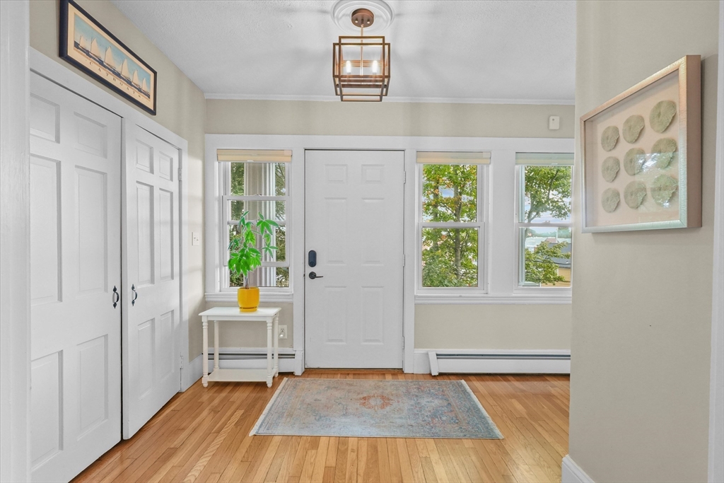 201 Humphrey Street, Unit 2 Marblehead, MA 01945 - Photo 6 of 31 a view of a livingroom with wooden floor and a window