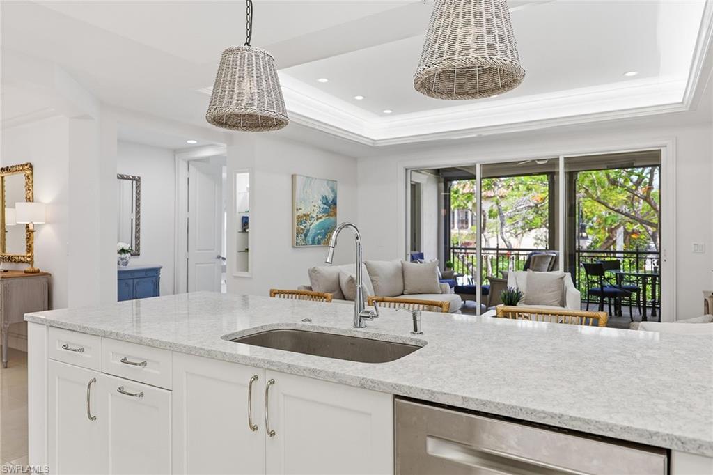 411 6th Street South, Unit 202 Naples, FL 34102 - Photo 11 of 37 a dining table with a sink and chandelier