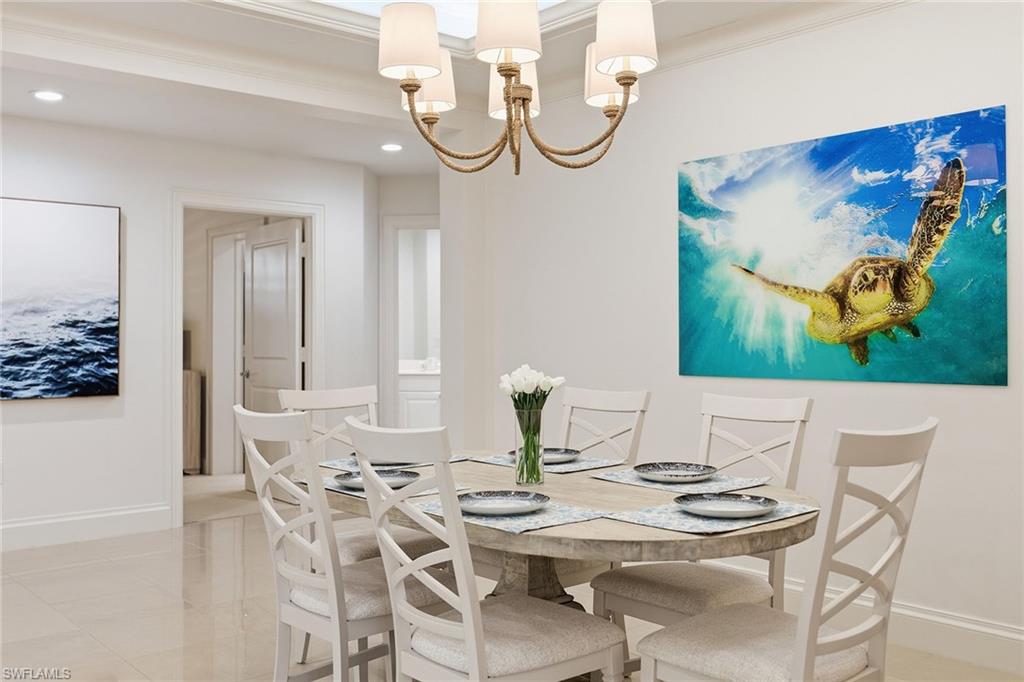 411 6th Street South, Unit 202 Naples, FL 34102 - Photo 12 of 37 a view of a dining room with furniture one side and wooden floor