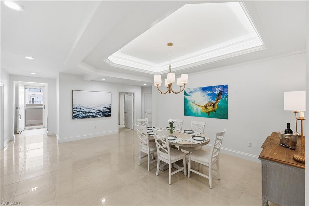 411 6th Street South, Unit 202 Naples, FL 34102 - Photo 15 of 37 a view of a dining room with furniture and wooden floor