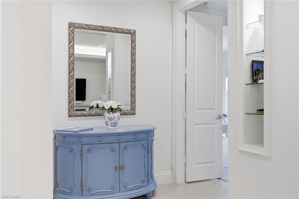 411 6th Street South, Unit 202 Naples, FL 34102 - Photo 17 of 37 a bathroom with a sink vanity and mirror