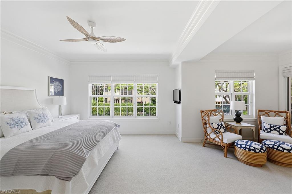 411 6th Street South, Unit 202 Naples, FL 34102 - Photo 19 of 37 a spacious bedroom with a bed and a couch