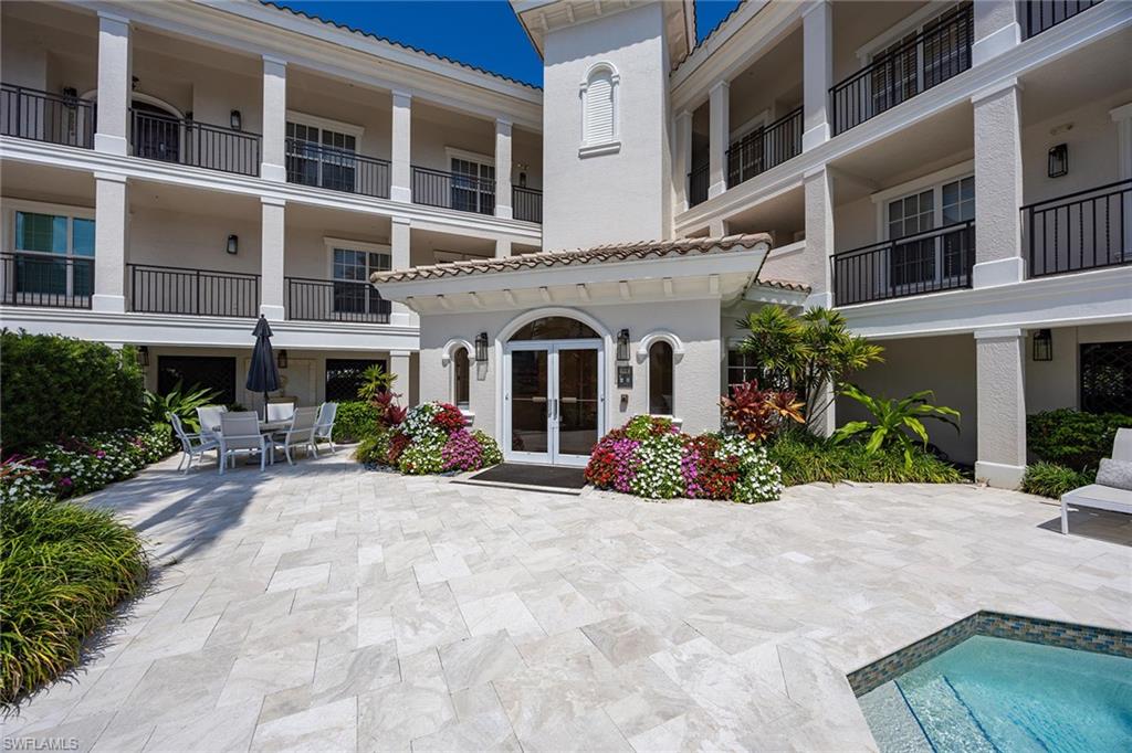 411 6th Street South, Unit 202 Naples, FL 34102 - Photo 2 of 37 a view of a building with sitting area