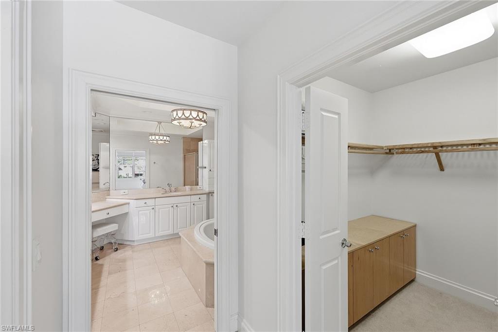 411 6th Street South, Unit 202 Naples, FL 34102 - Photo 22 of 37 a bathroom with a shower sink and mirror
