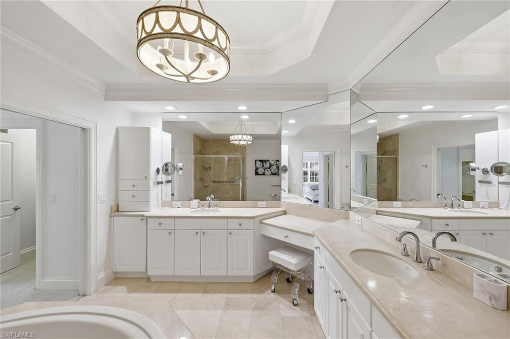 411 6th Street South, Unit 202 Naples, FL 34102 - Photo 23 of 37 a large bathroom with a sink a large mirror and a bathtub