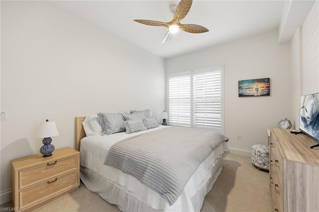 411 6th Street South, Unit 202 Naples, FL 34102 - Photo 28 of 37 a bedroom with a bed and a dresser