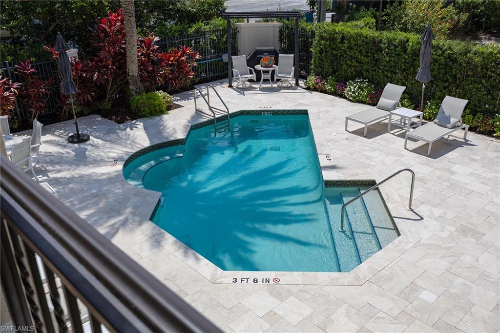 411 6th Street South, Unit 202 Naples, FL 34102 - Photo 33 of 37 a view of a backyard with sitting area
