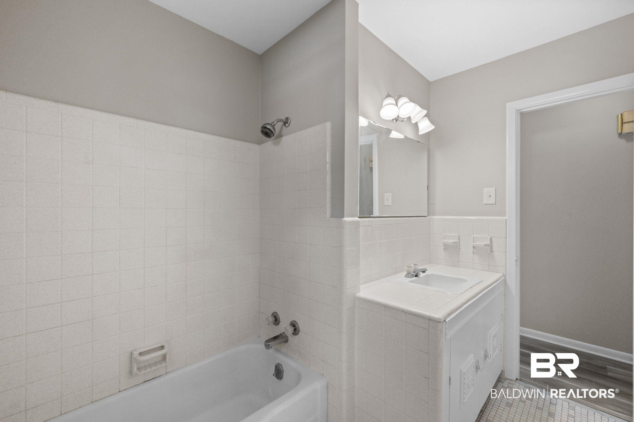 909 Caroline Avenue Daphne, AL 36526 - Photo 26 of 46 Bathroom featuring vanity and shower / washtub combination