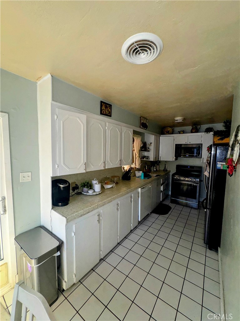9778 Sharon Avenue Riverside, CA 92503 - Photo 13 of 19 a kitchen with a sink and cabinets