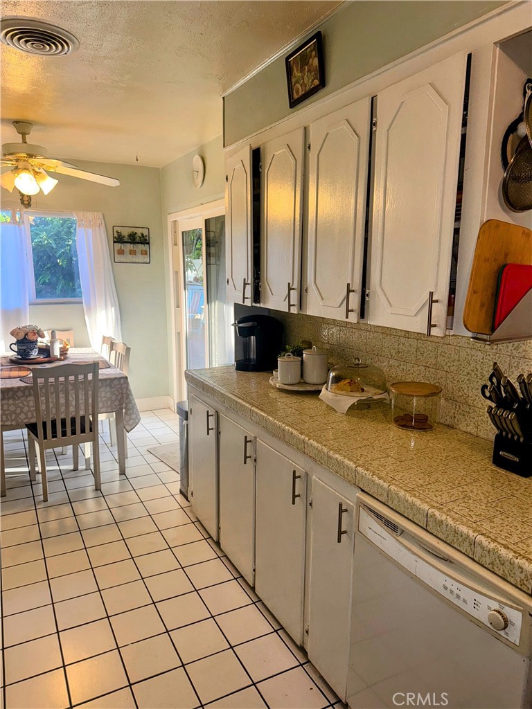 9778 Sharon Avenue Riverside, CA 92503 - Photo 14 of 19 a spacious bathroom with a granite countertop sink and a mirror