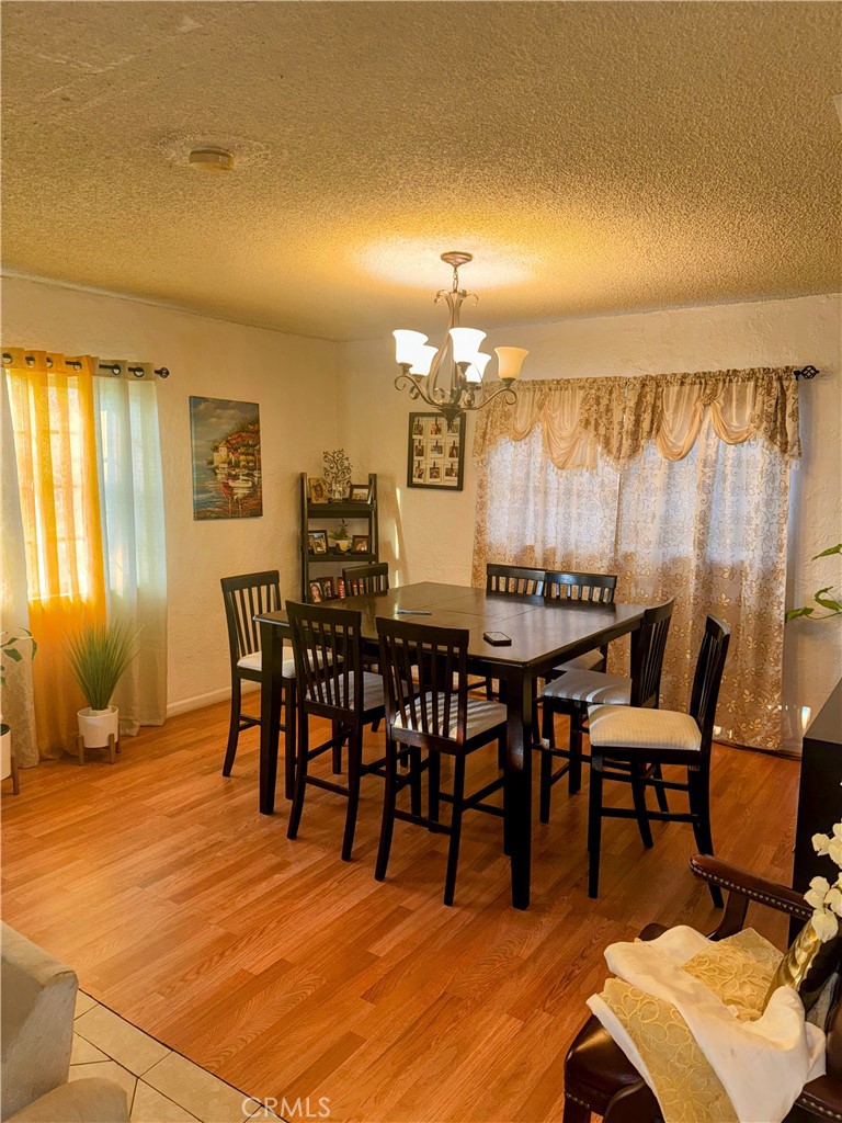 9778 Sharon Avenue Riverside, CA 92503 - Photo 17 of 19 a view of a dining room with furniture and chandelier