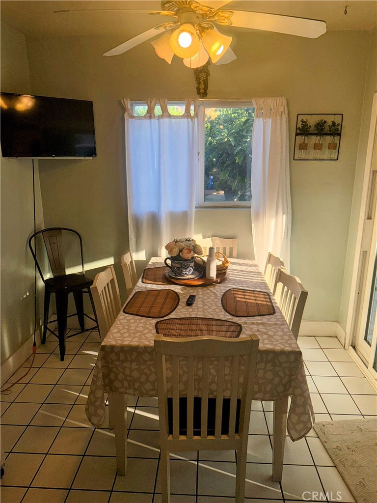 9778 Sharon Avenue Riverside, CA 92503 - Photo 18 of 19 a kitchen with a table chairs and a sink