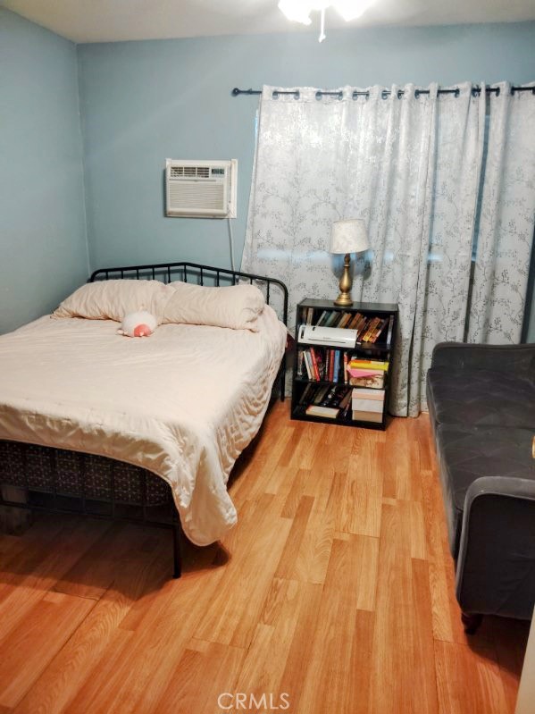 9778 Sharon Avenue Riverside, CA 92503 - Photo 7 of 19 a bed sitting in a bedroom next to a window with rug