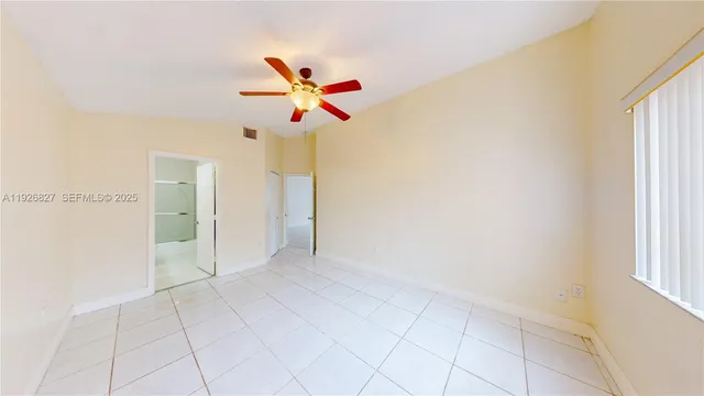 a view of a livingroom with a ceiling fan and window