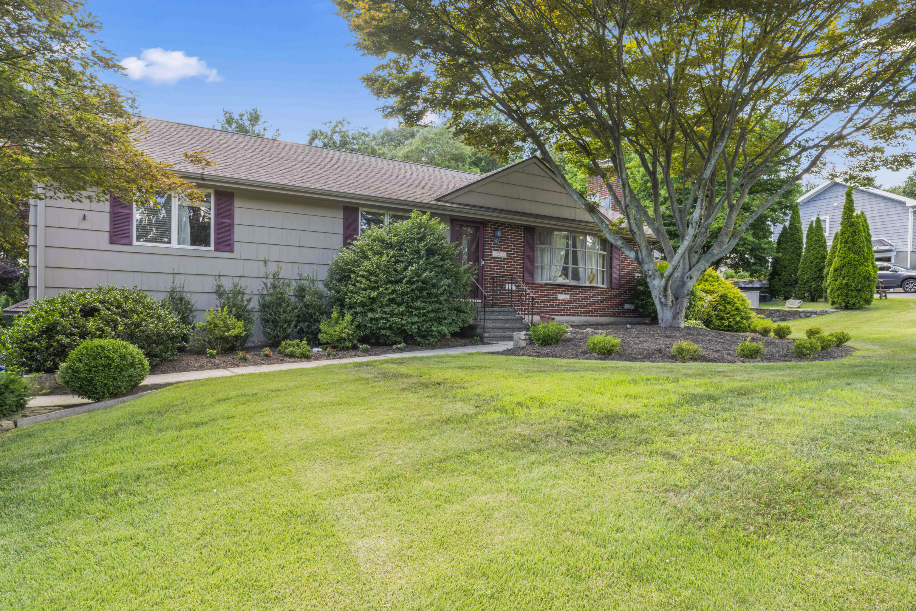 a front view of a house with garden