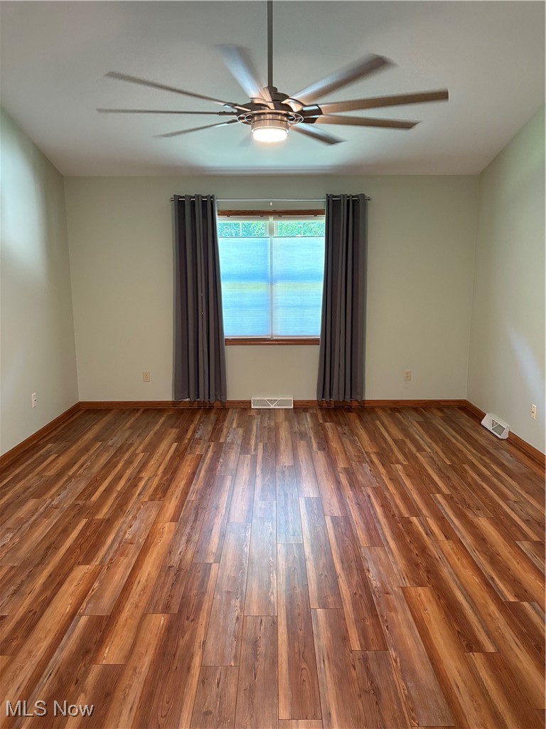 6695 Clingan Road, Unit 24 Youngstown, OH 44514 - Photo 7 of 26 Spare room featuring wood finished floors and ceiling fan