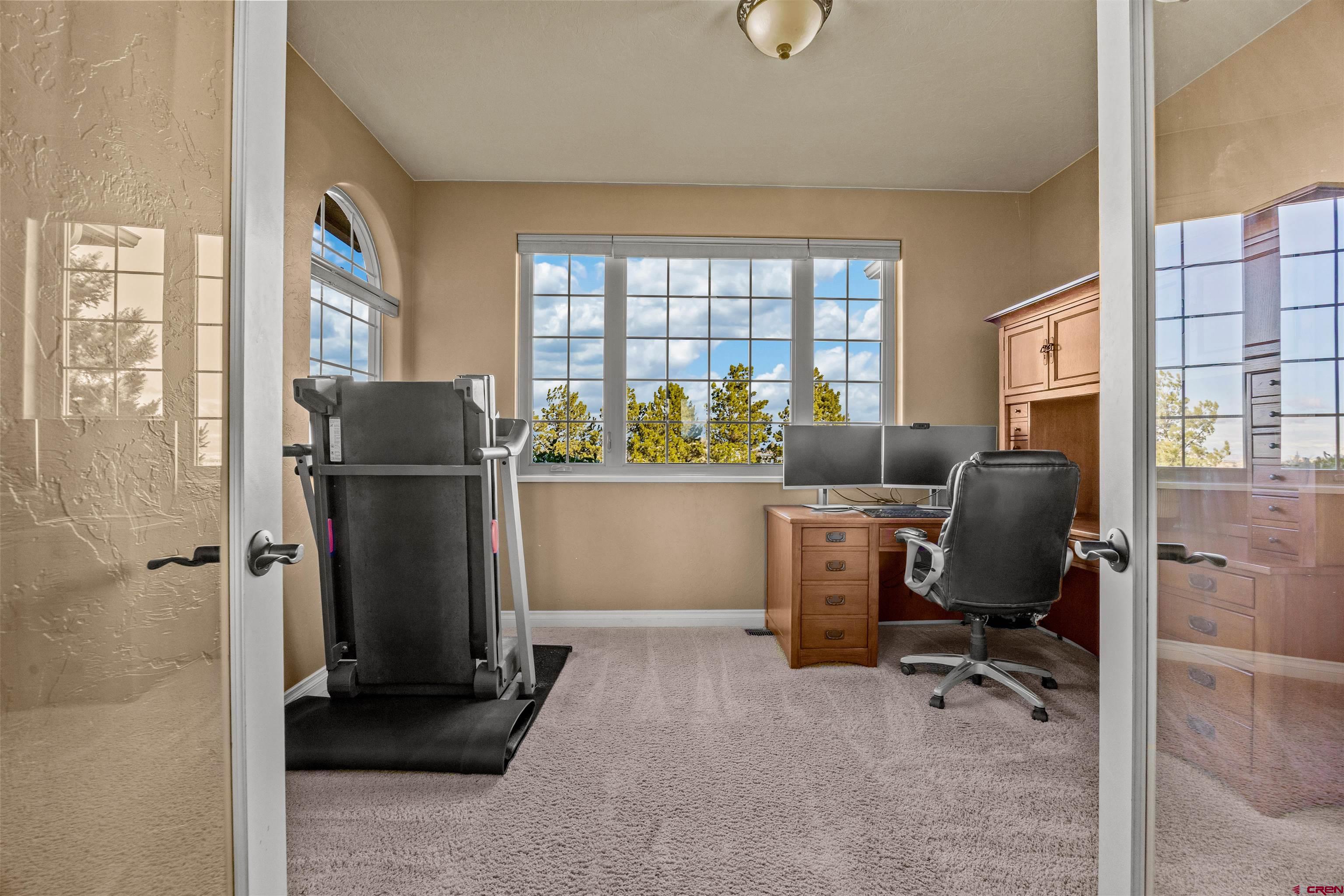 9838 5650th Road Olathe, CO 81425 - Photo 15 of 44 a view of a workspace with furniture and a window