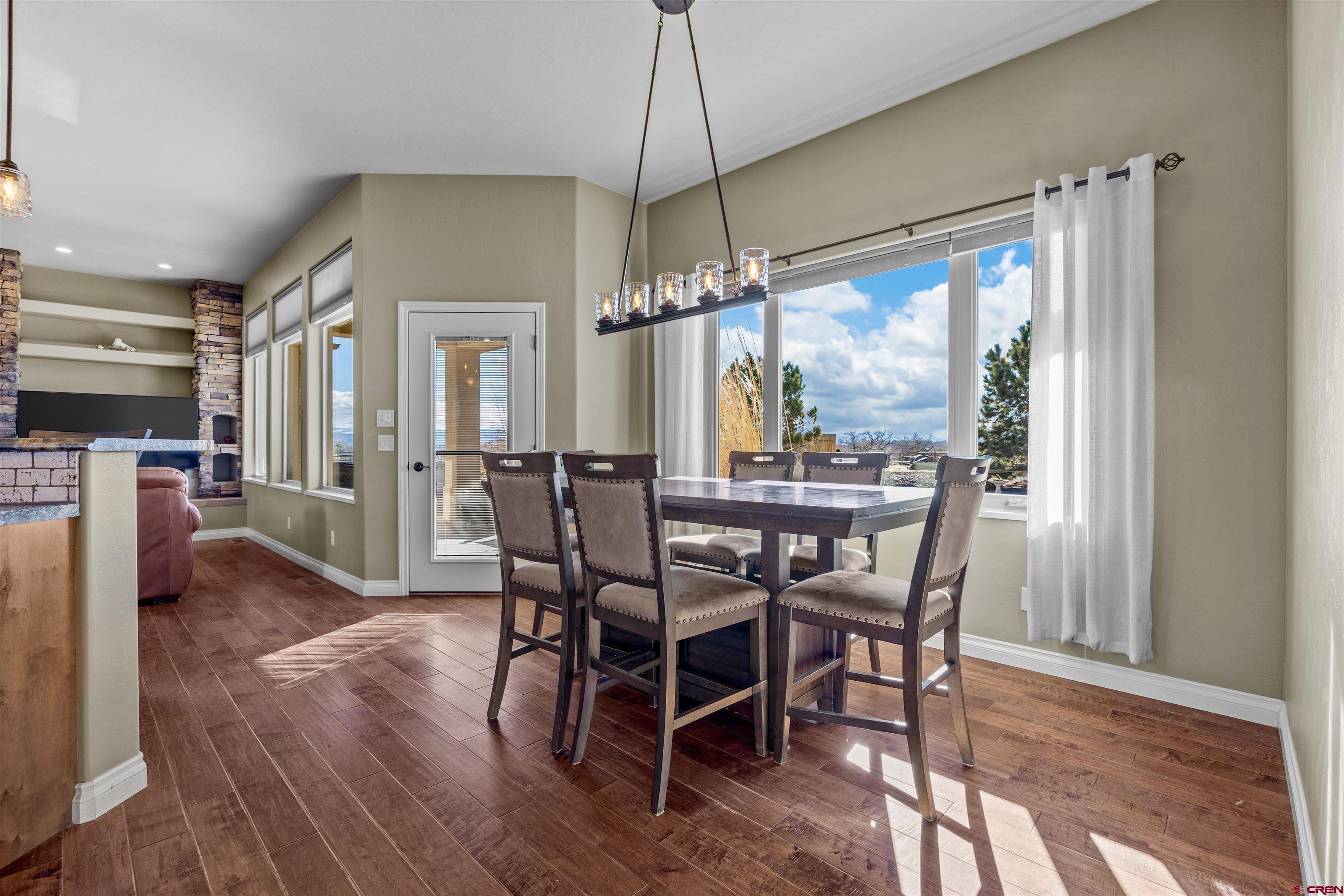 9838 5650th Road Olathe, CO 81425 - Photo 6 of 44 a dining room with furniture window and wooden floor