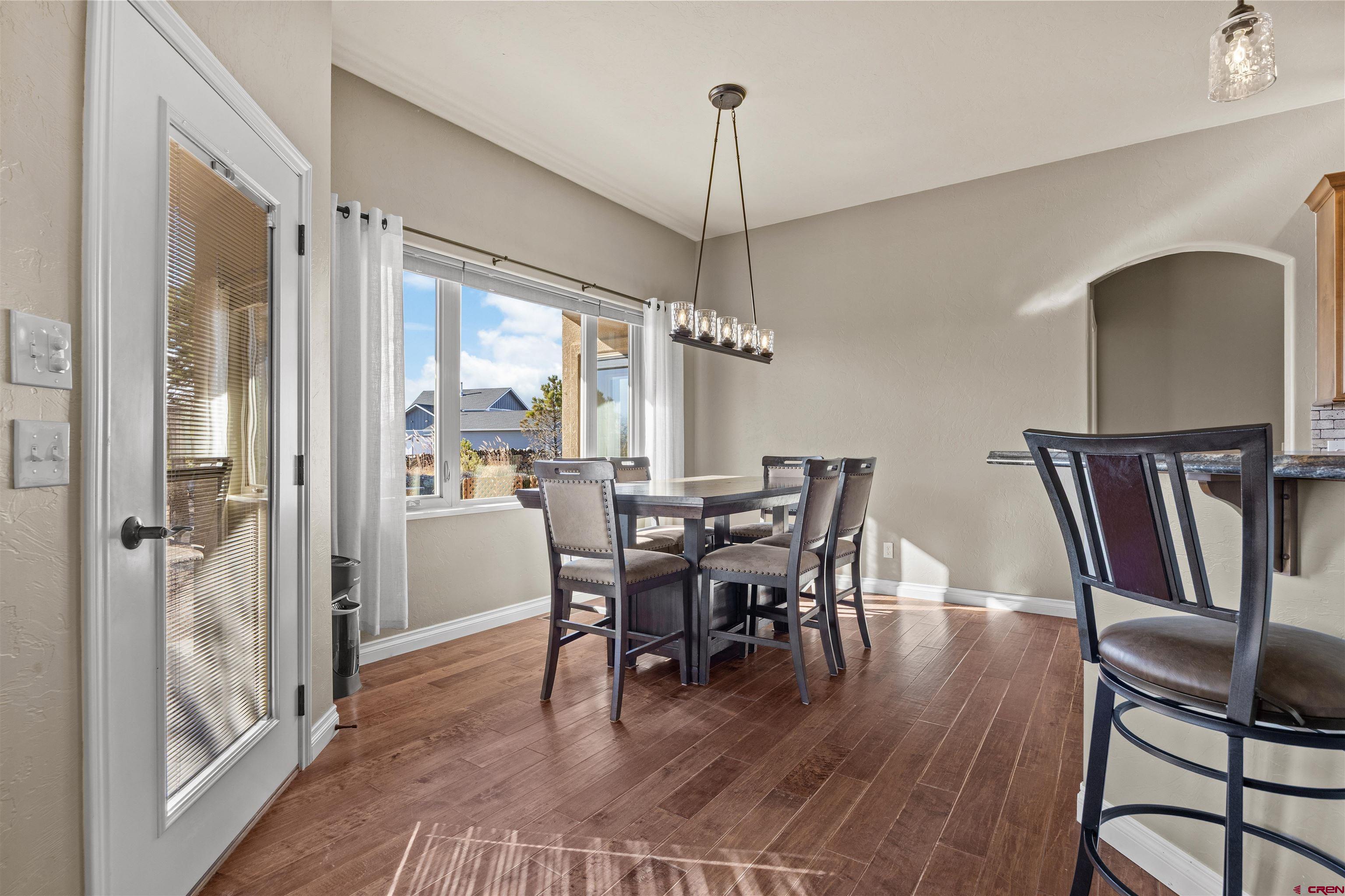 9838 5650th Road Olathe, CO 81425 - Photo 7 of 44 a view of a dining room with furniture window and wooden floor