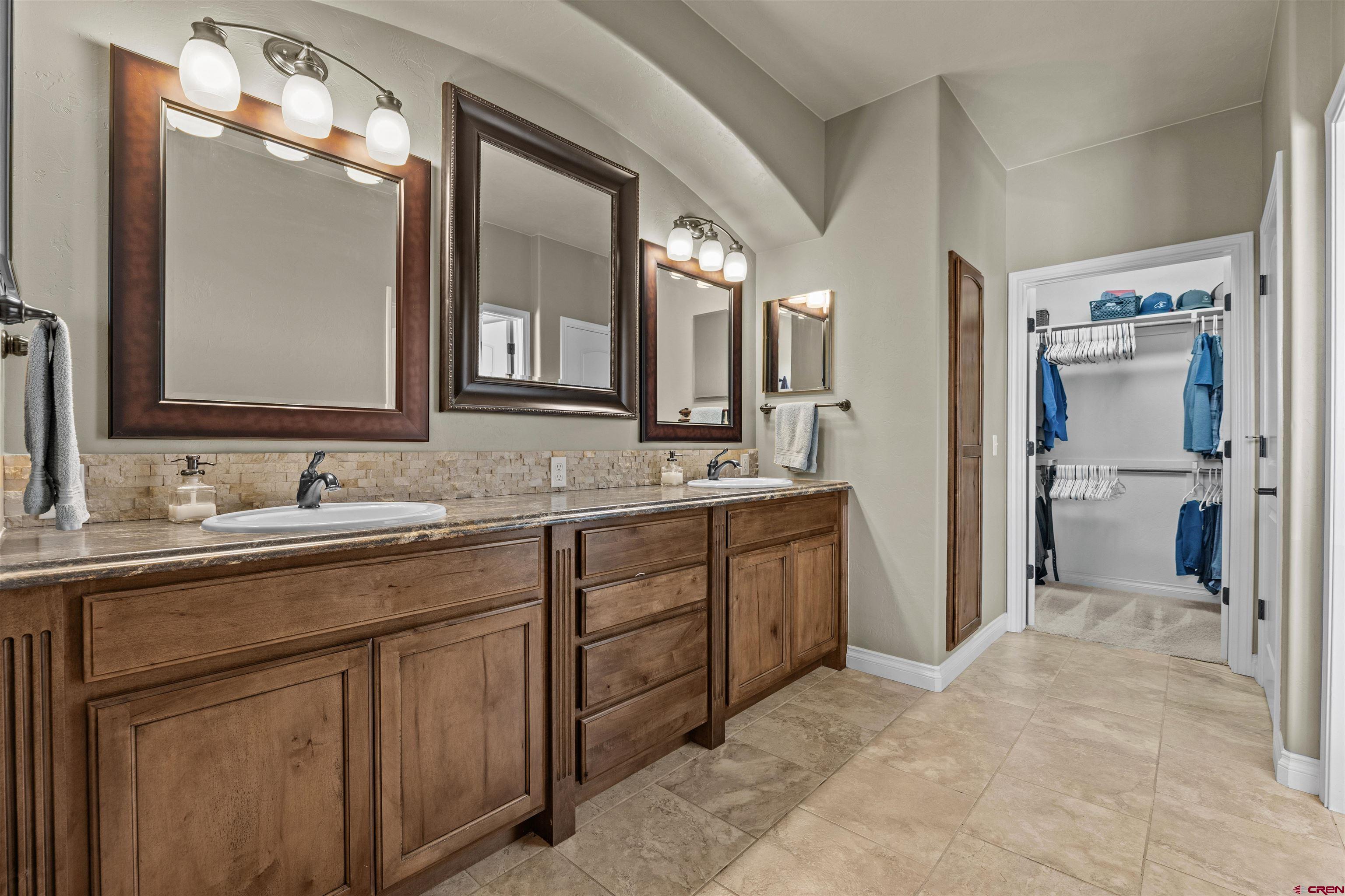 9838 5650th Road Olathe, CO 81425 - Photo 10 of 44 a spacious bathroom with a granite countertop sink mirror and shower