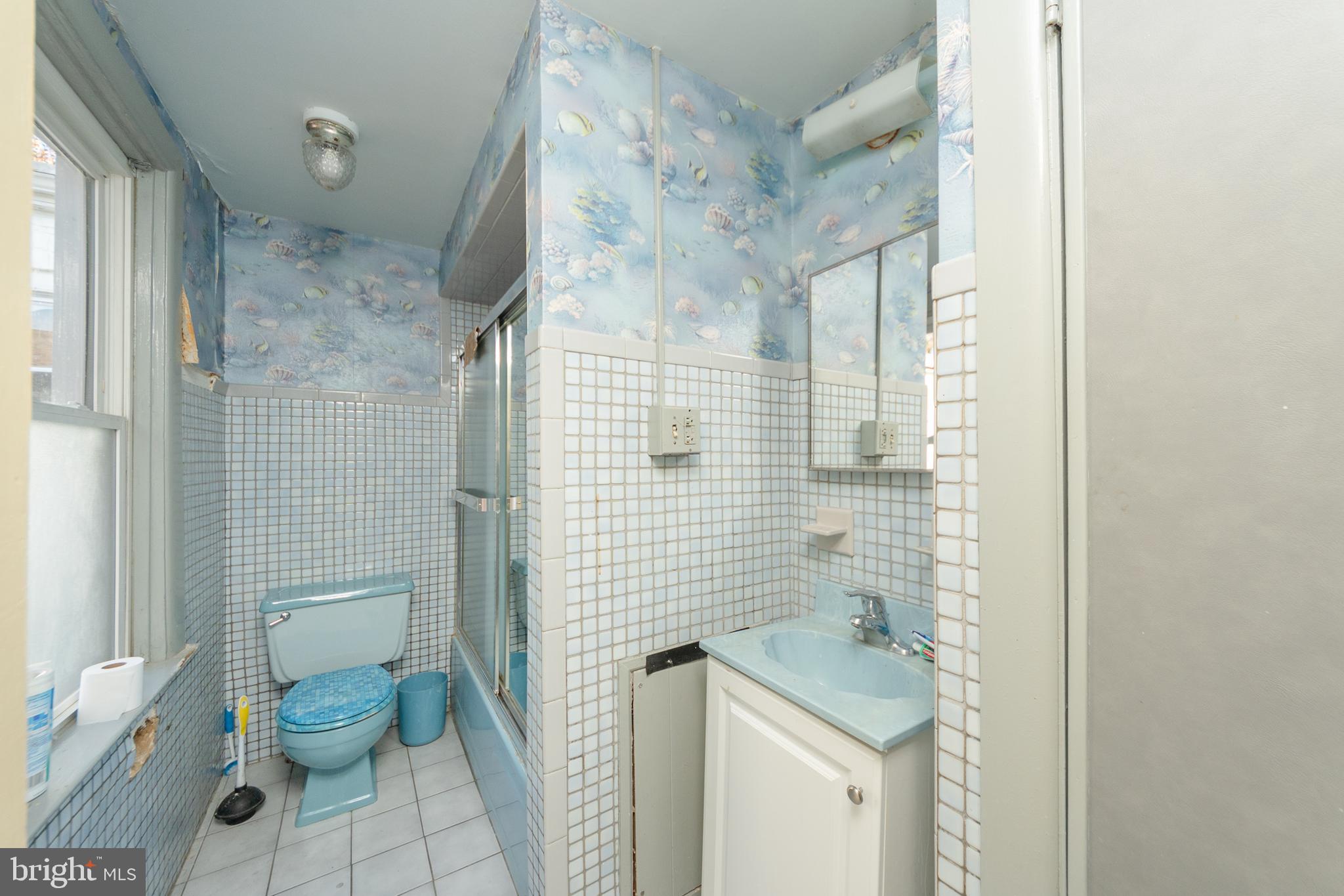 758 South Lime Street Lancaster, PA 17602 - Photo 7 of 28 a bathroom with a granite countertop shower a toilet and a sink