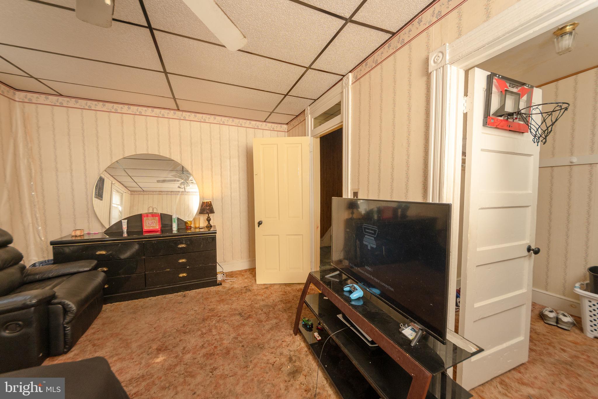 758 South Lime Street Lancaster, PA 17602 - Photo 9 of 28 a living room with a bed furniture and a flat screen tv