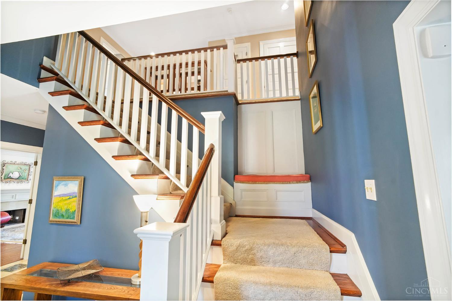 2780 Walsh Road Cincinnati, OH 45208 - Photo 24 of 68 The gracious, light-filled stairway with classic white balusters and warm wood accents leads to the expansive second floor. This level offers five well-appointed bedrooms and three full baths, thoughtfully arranged to provide both comfort and flexibility for everyday living, guests, or work-from-home needs.