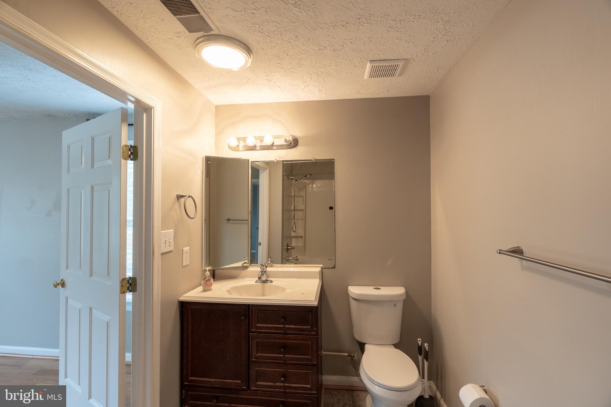 689 Winding Stream Way, Unit 101 Odenton, MD 21113 - Photo 14 of 23 a bathroom with a toilet sink and mirror