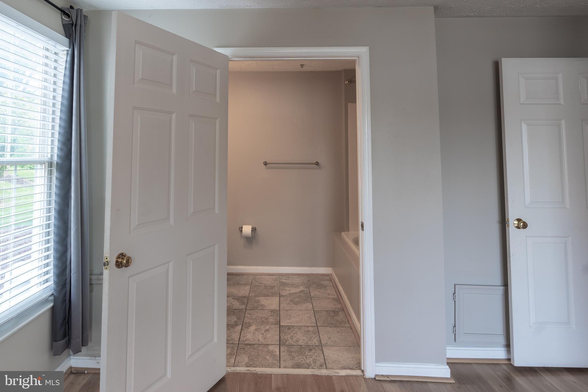 689 Winding Stream Way, Unit 101 Odenton, MD 21113 - Photo 15 of 23 a view of a hallway with wooden floor and closet