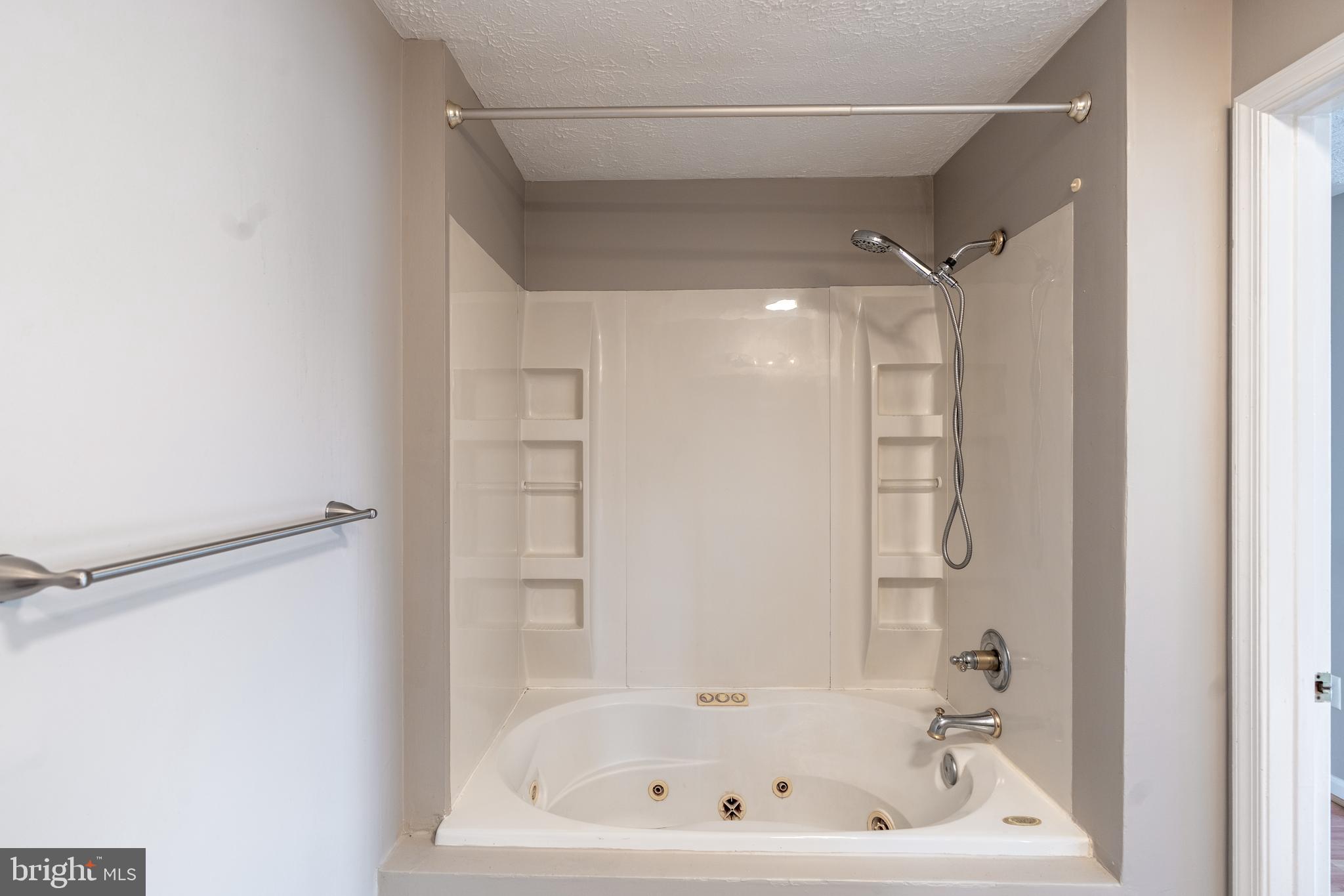 689 Winding Stream Way, Unit 101 Odenton, MD 21113 - Photo 16 of 23 a bathroom with a bathtub and a shower