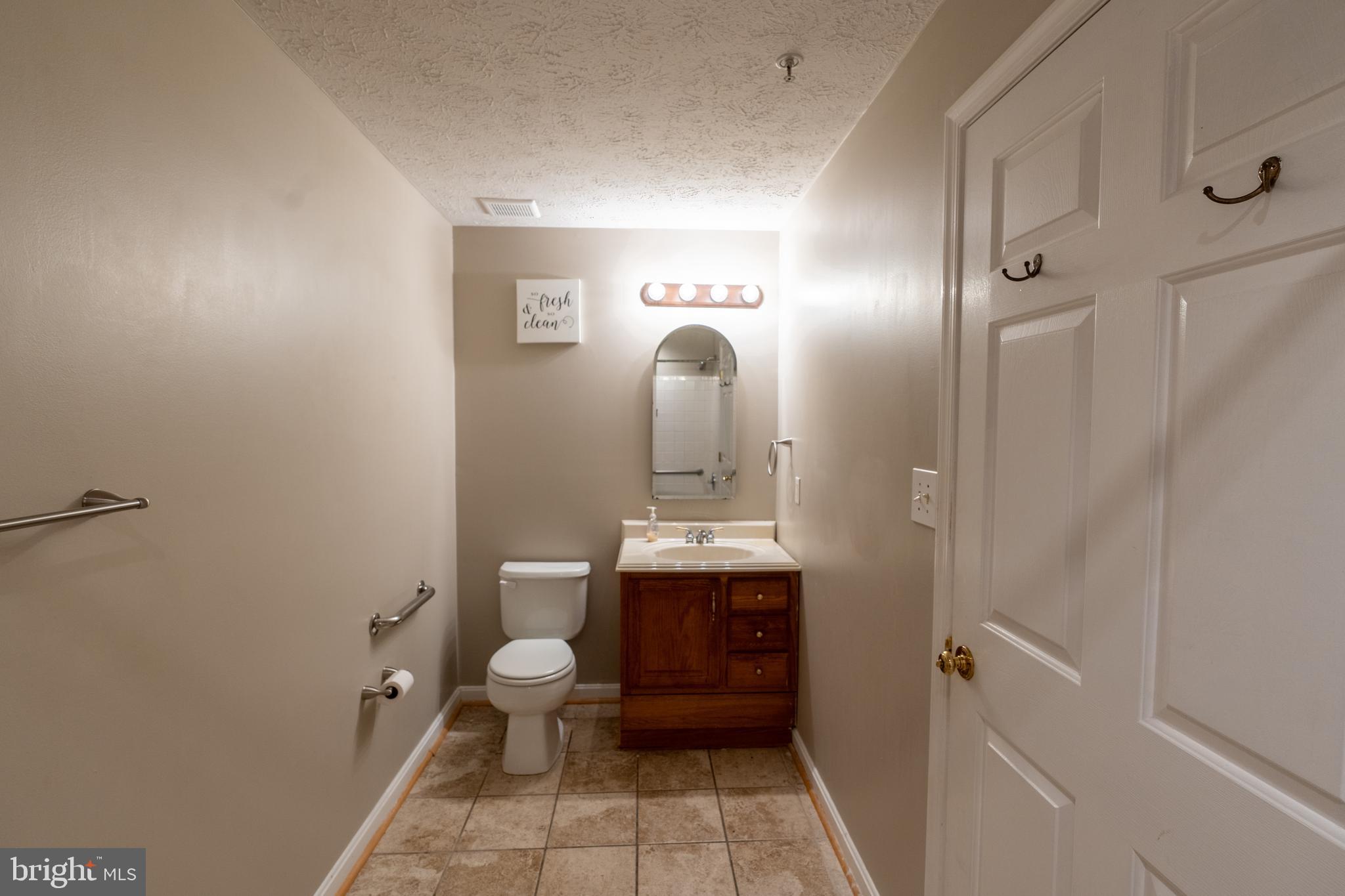 689 Winding Stream Way, Unit 101 Odenton, MD 21113 - Photo 19 of 23 a bathroom with a sink mirror toilet and vanity