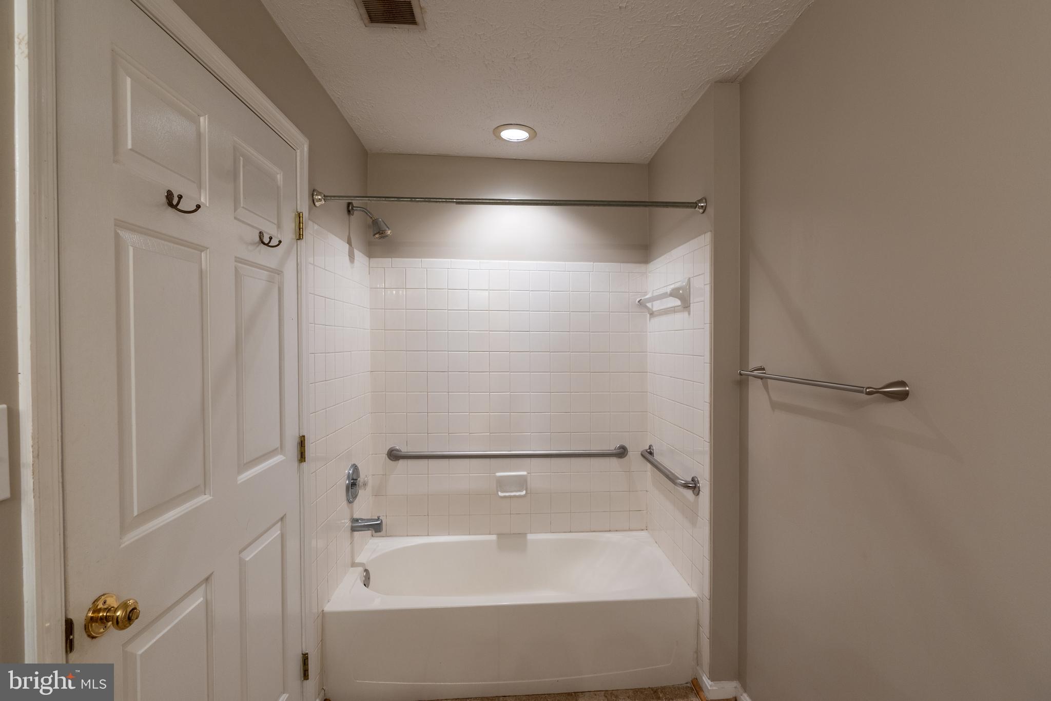 689 Winding Stream Way, Unit 101 Odenton, MD 21113 - Photo 20 of 23 a bathroom with a bathtub and a shower