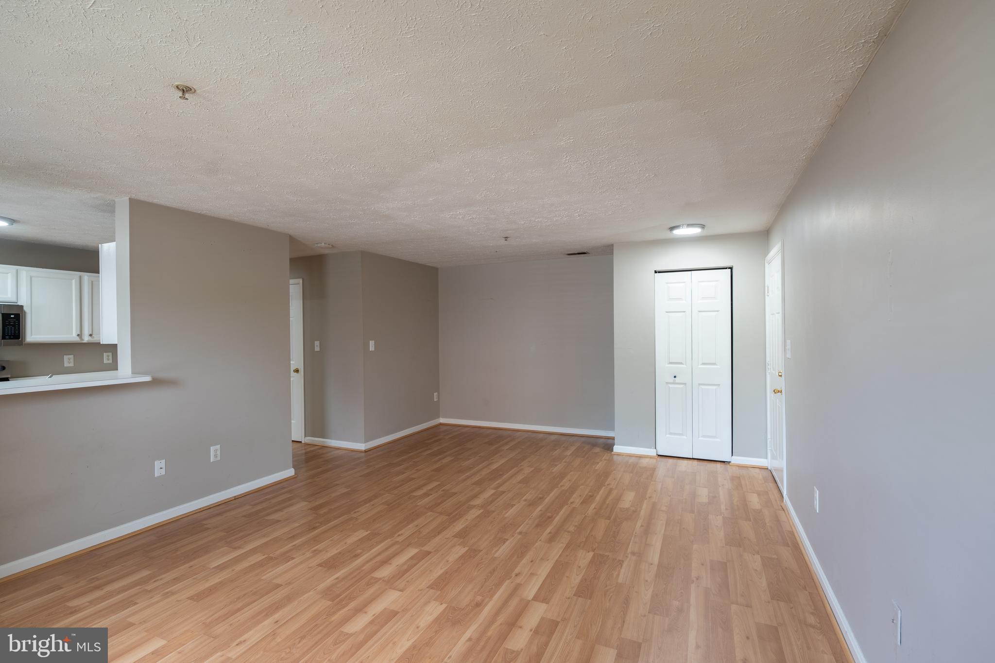 689 Winding Stream Way, Unit 101 Odenton, MD 21113 - Photo 3 of 23 a view of an empty room and wooden floor