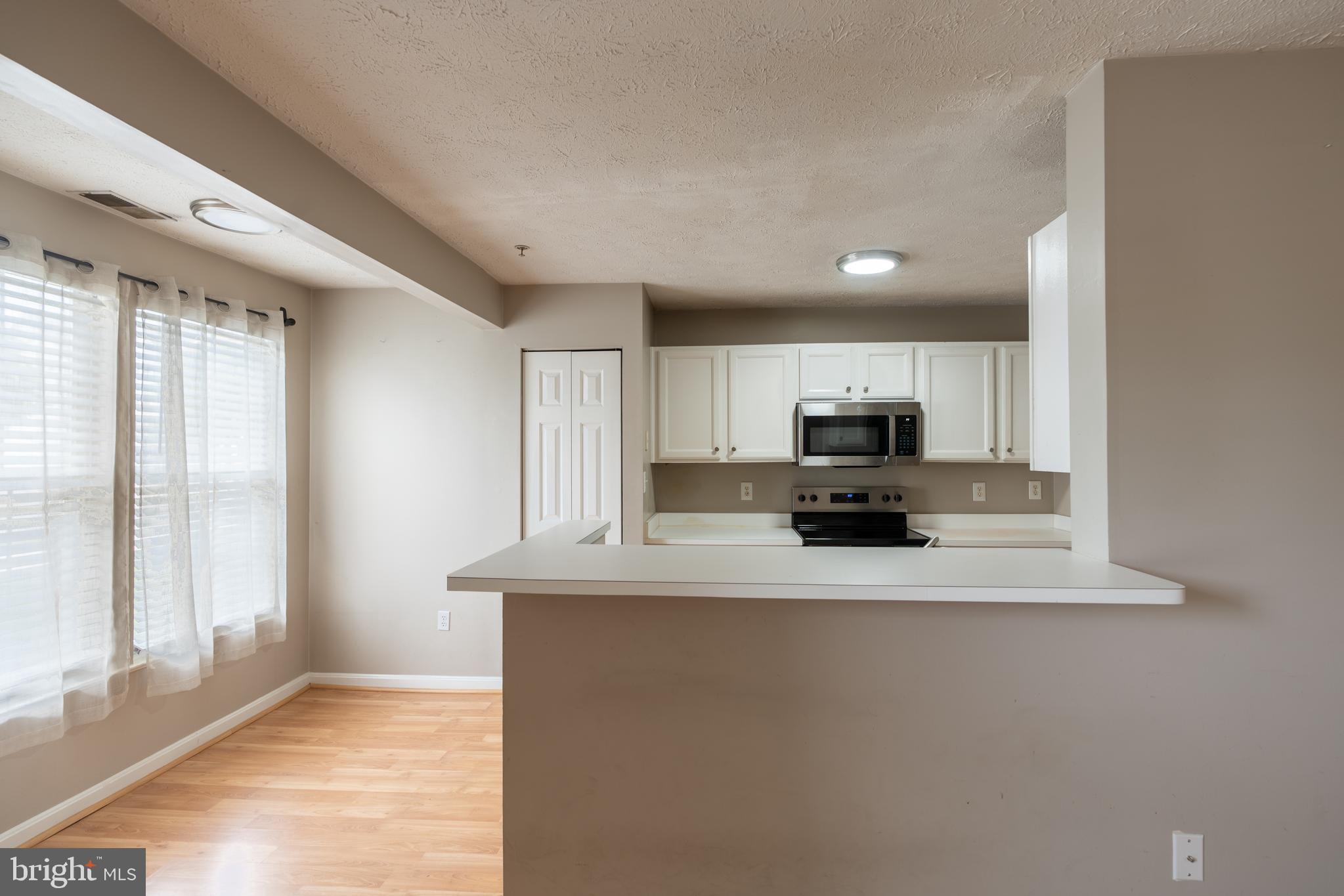 689 Winding Stream Way, Unit 101 Odenton, MD 21113 - Photo 8 of 23 a view of kitchen with microwave and refrigerator