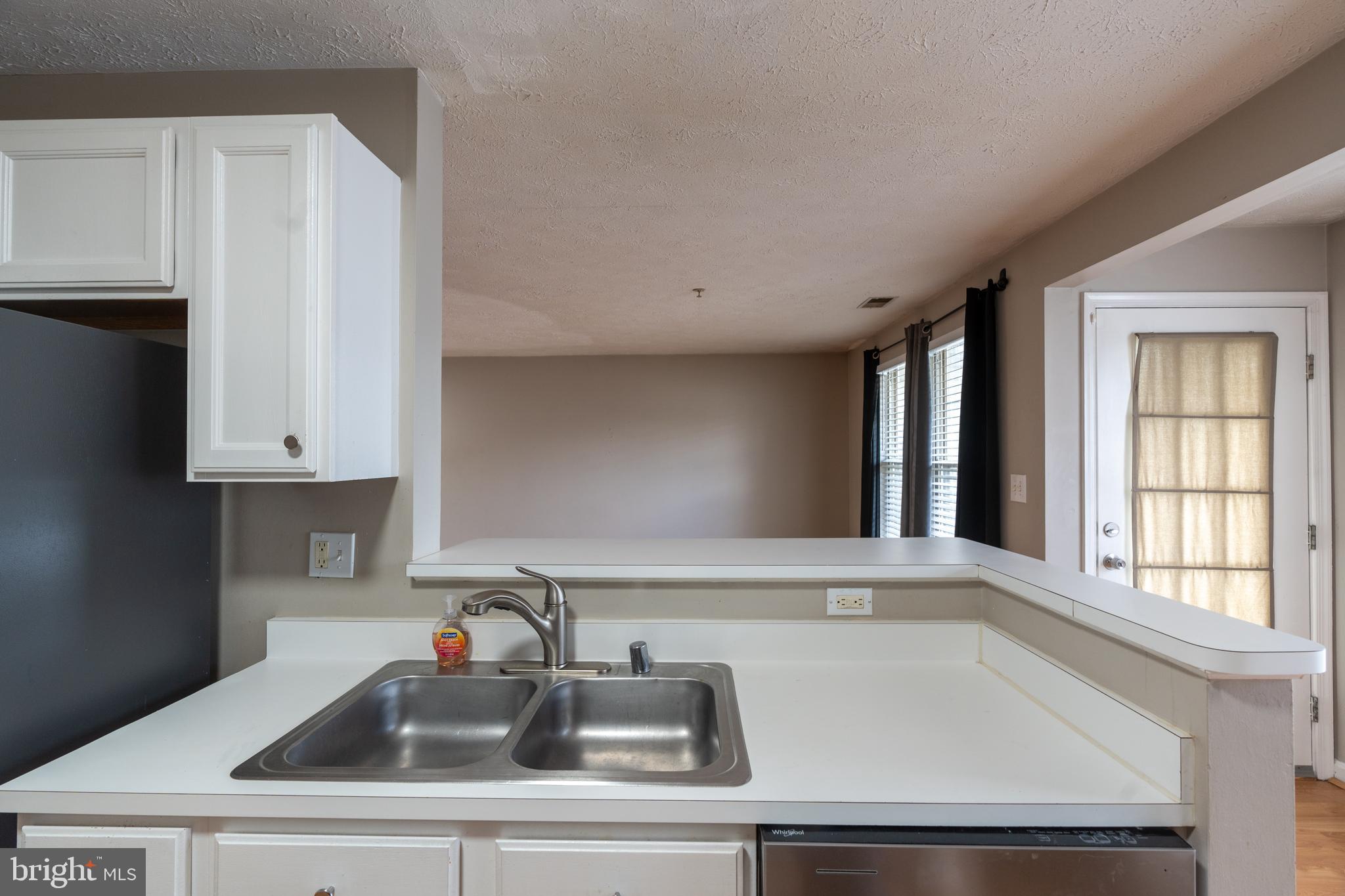 689 Winding Stream Way, Unit 101 Odenton, MD 21113 - Photo 9 of 23 a kitchen with a sink and cabinets