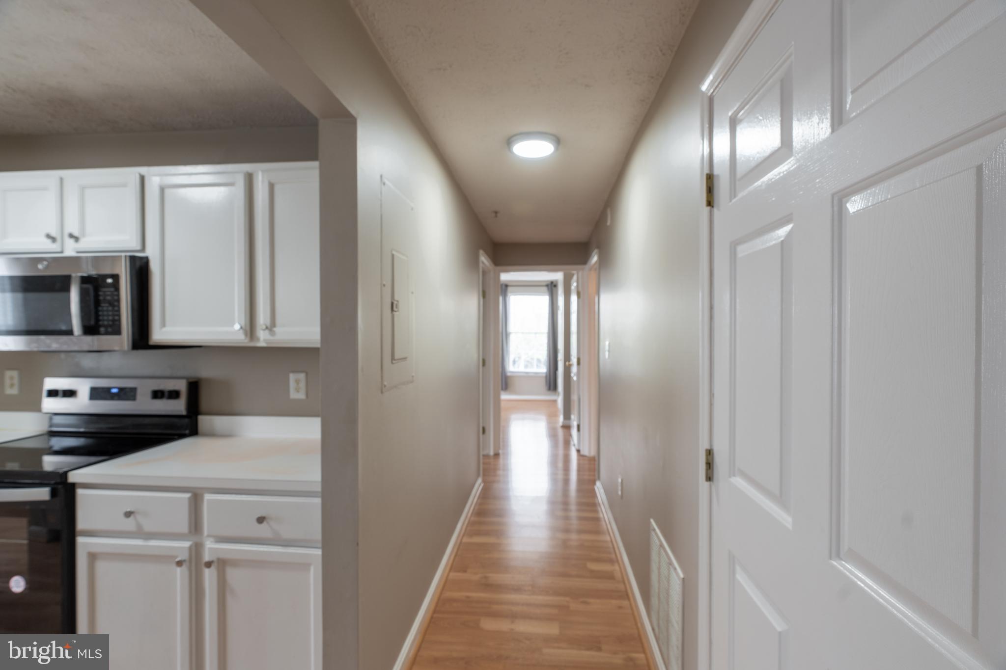 689 Winding Stream Way, Unit 101 Odenton, MD 21113 - Photo 10 of 23 a view of a hallway with stainless steel appliances granite countertop cabinets and a window