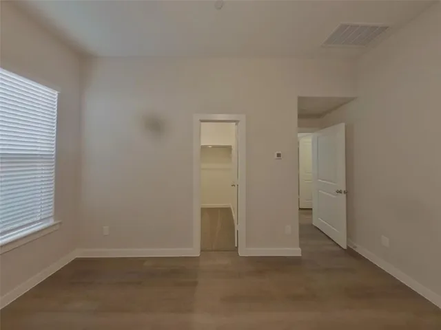 an empty room with closet and a window