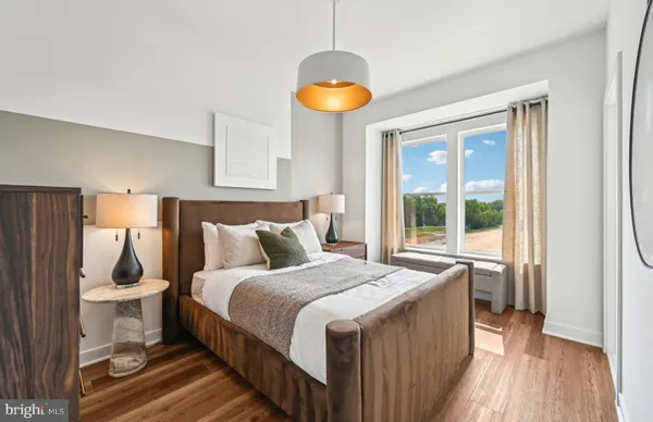 a bedroom with a bed and a lamp on table