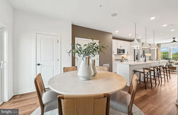 a dining room with furniture and wooden floor