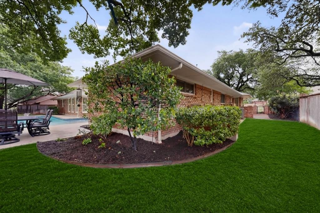 2405 Wing Point Lane Plano, TX 75093 - Photo 38 of 39 a view of a backyard with table and chairs potted plants and large tree