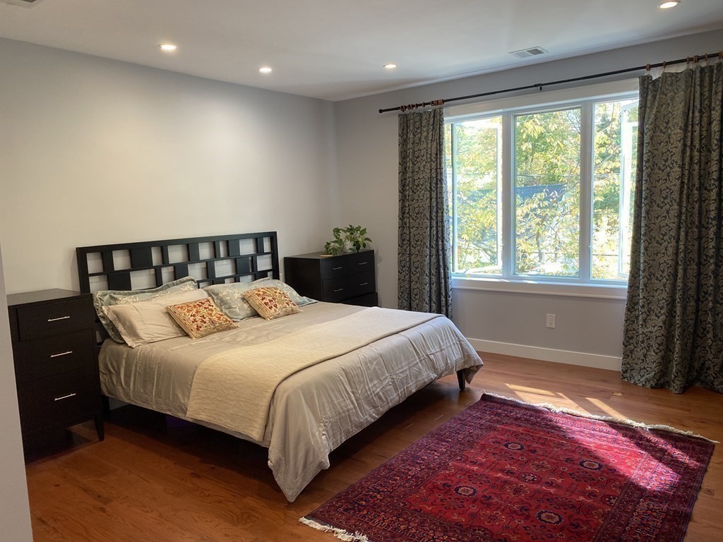 9 York Road Newton, MA 02468 - Photo 17 of 41 a bedroom with a large bed and a window