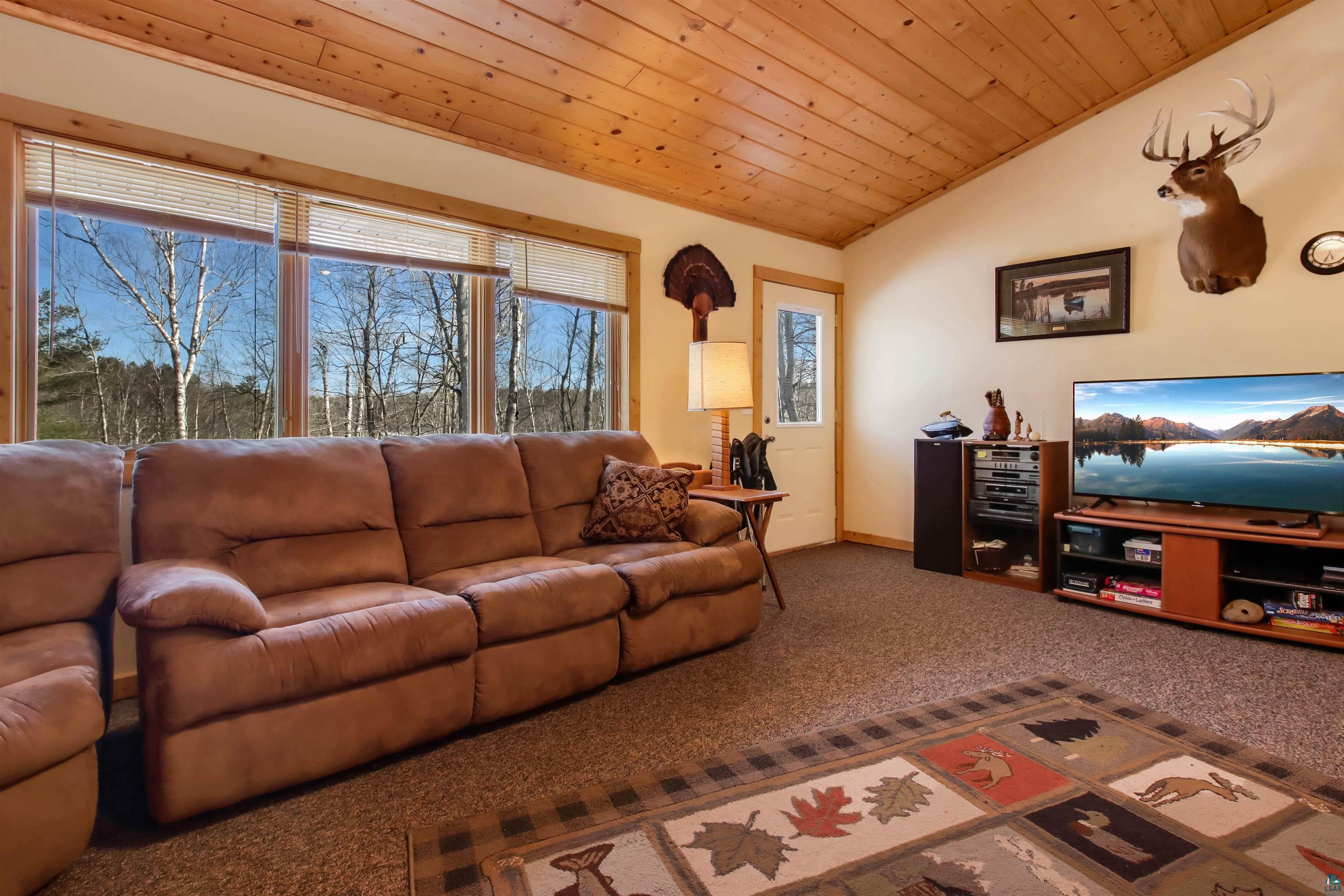 16525 Sand Hill Road Mason, WI 54856 - Photo 5 of 38 Carpeted living room with baseboards, vaulted ceiling, and wooden ceiling